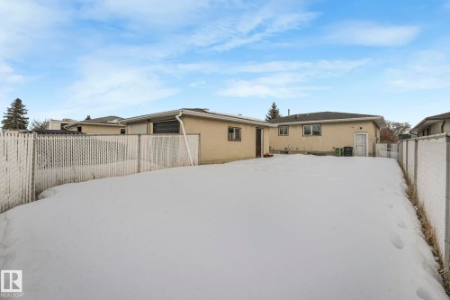 Snow covered house with a fenced backyard and stucco siding - 14924 81 Street, Edmonton, AB 