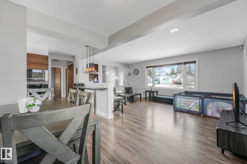 Dining room featuring light wood finished floors and beam ceiling - 14924 81 Street, Edmonton, AB 