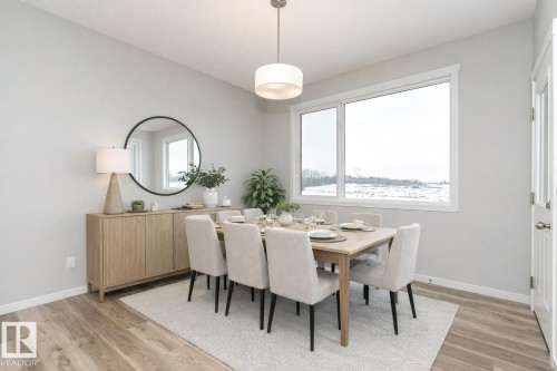 Dining space featuring light wood-style flooring - 3949 Wren Loop, Edmonton, AB - Indoor Photo Showing Dining Room