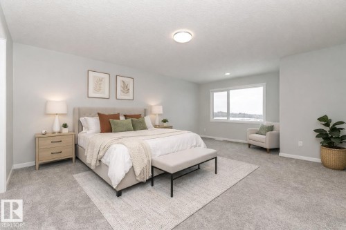 Bedroom with light colored carpet and a textured ceiling - 3949 Wren Loop, Edmonton, AB - Indoor Photo Showing Bedroom
