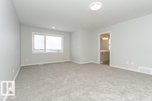 Spare room featuring light colored carpet, a textured ceiling, and recessed lighting - 3949 Wren Loop, Edmonton, AB - Indoor Photo Showing Other Room