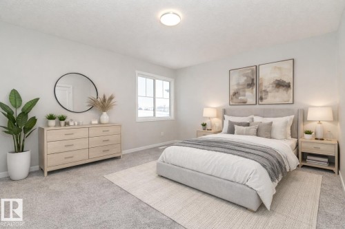 Carpeted bedroom with a textured ceiling and baseboards - 3949 Wren Loop, Edmonton, AB - Indoor Photo Showing Bedroom