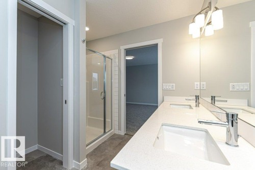 Bathroom with a shower stall, double vanity, and a textured ceiling - 3949 Wren Loop, Edmonton, AB - Indoor Photo Showing Bathroom