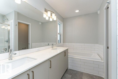 Full bath featuring double vanity, a garden tub, and a shower stall - 3949 Wren Loop, Edmonton, AB - Indoor Photo Showing Bathroom
