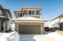 View of front of house with brick siding, an attached garage, and driveway - 3949 Wren Loop, Edmonton, AB  - Outdoor With Exterior 