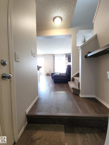 Hall featuring dark wood-type flooring and a textured ceiling - 5424 204 Street, Edmonton, AB - Indoor Photo Showing Other Room