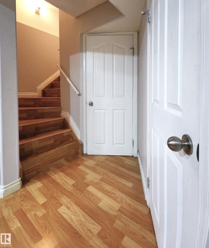 Stairway with wood finished floors and baseboards - 5424 204 Street, Edmonton, AB - Indoor Photo Showing Other Room