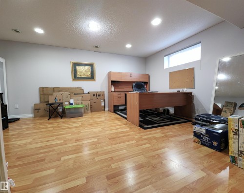 Office featuring light wood-style flooring, a textured ceiling, and recessed lighting - 5424 204 Street, Edmonton, AB - Indoor