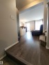Corridor with a textured ceiling, dark wood-style floors, and hanging lights - 5424 204 Street, Edmonton, AB  - Indoor 