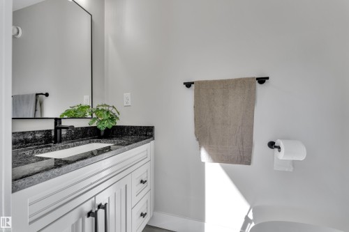 Half bath with vanity and baseboards - 7613 16 Av Sw, Edmonton, AB - Indoor Photo Showing Bathroom