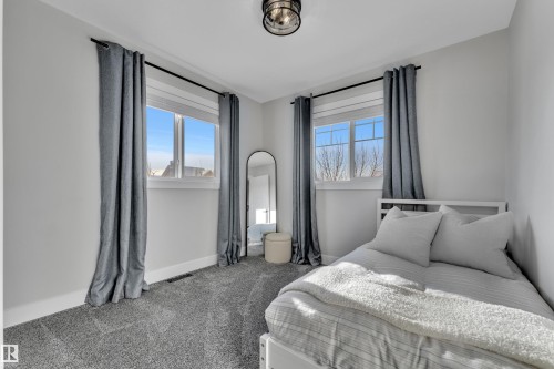 Bedroom with carpet and baseboards - 7613 16 Av Sw, Edmonton, AB - Indoor Photo Showing Bedroom