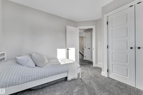 Bedroom featuring carpet and baseboards - 7613 16 Av Sw, Edmonton, AB - Indoor Photo Showing Bedroom