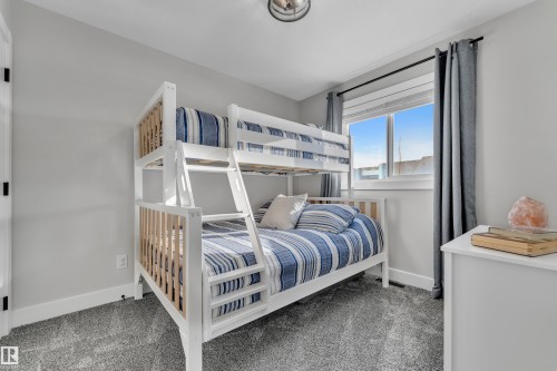 Carpeted bedroom with baseboards - 7613 16 Av Sw, Edmonton, AB - Indoor Photo Showing Bedroom