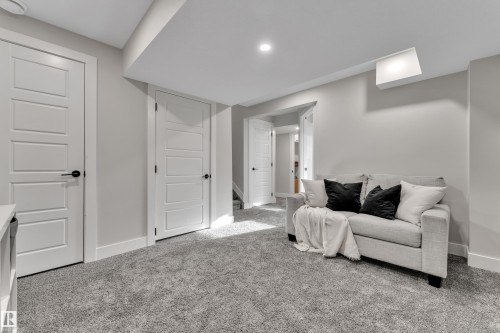 Living area featuring baseboards and carpet - 7613 16 Av Sw, Edmonton, AB - Indoor