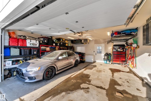 Garage featuring a heating unit - 7613 16 Av Sw, Edmonton, AB - Indoor Photo Showing Garage