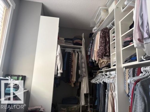 11x7 walk-in closet with lots of built-in storage units - 867 Armitage Wynd Sw, Edmonton, AB - Indoor With Storage