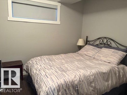 Guest bedroom with laminate flooring. - 867 Armitage Wynd Sw, Edmonton, AB - Indoor Photo Showing Bedroom