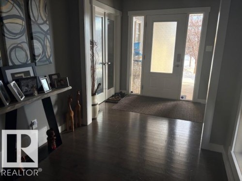 Foyer entrance featuring dark wood-style floors and healthy amount of natural light - 867 Armitage Wynd Sw, Edmonton, AB - Indoor Photo Showing Other Room