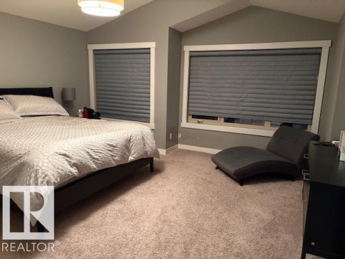 Bedroom with vaulted ceiling and light colored carpet - 867 Armitage Wynd Sw, Edmonton, AB - Indoor Photo Showing Bedroom
