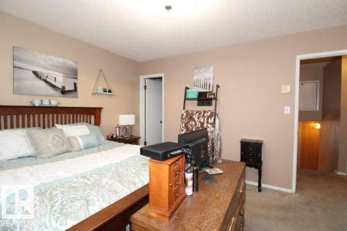 Bedroom with a textured ceiling and light colored carpet - 2812 35 Street Nw, Edmonton, AB - Indoor Photo Showing Bedroom