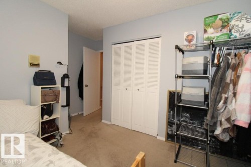 Bedroom with light carpet, a closet, and a textured ceiling - 2812 35 Street Nw, Edmonton, AB - Indoor