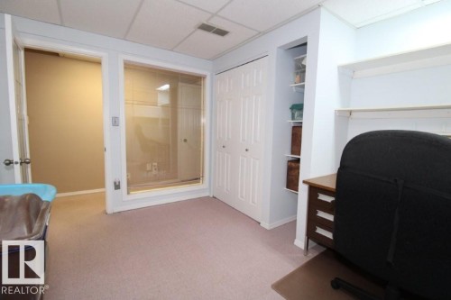 Home office with a paneled ceiling, light colored carpet, and built in shelves - 2812 35 Street Nw, Edmonton, AB - Indoor Photo Showing Office