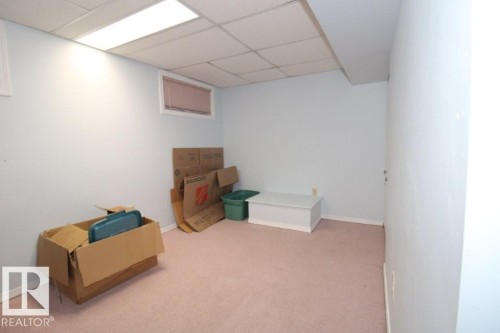 Finished below grade area featuring carpet floors and a paneled ceiling - 2812 35 Street Nw, Edmonton, AB - Indoor