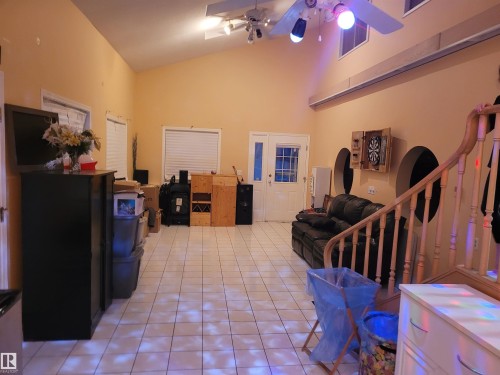 Interior space featuring ceiling fan, light tile patterned flooring, and lofted ceiling - 2812 35 Street Nw, Edmonton, AB - Indoor Photo Showing Other Room