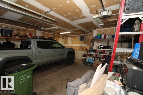 Garage with a garage door opener and a heating unit - 2812 35 Street Nw, Edmonton, AB - Indoor Photo Showing Garage