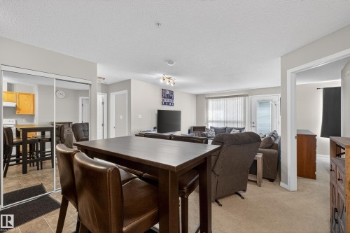 Dining room with a textured ceiling and baseboards - 131 1520 Hammong Gate, Edmonton, AB - Indoor Photo Showing Dining Room