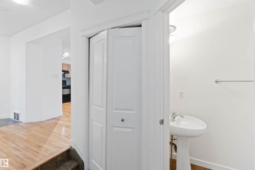 Bathroom featuring dark wood-style floors and a closet - 4507 164A Avenue, Edmonton, AB - Indoor Photo Showing Bathroom