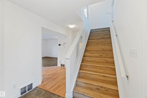 Staircase featuring wood finished floors and baseboards - 4507 164A Avenue, Edmonton, AB - Indoor Photo Showing Other Room