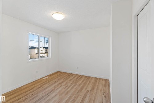 Spare room featuring light wood-style flooring and baseboards - 4507 164A Avenue, Edmonton, AB - Indoor Photo Showing Other Room