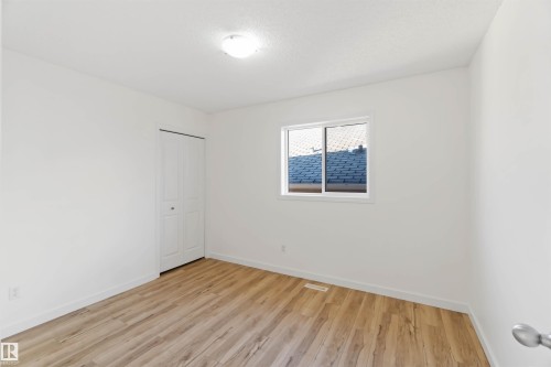Unfurnished room with baseboards and light wood-style floors - 4507 164A Avenue, Edmonton, AB - Indoor Photo Showing Other Room