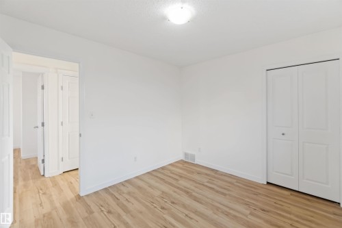 Unfurnished bedroom featuring light wood-style flooring and a closet - 4507 164A Avenue, Edmonton, AB - Indoor Photo Showing Other Room