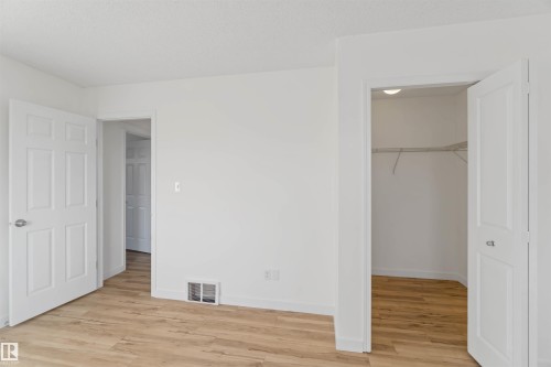 Unfurnished bedroom featuring light wood-style floors and a spacious closet - 4507 164A Avenue, Edmonton, AB - Indoor