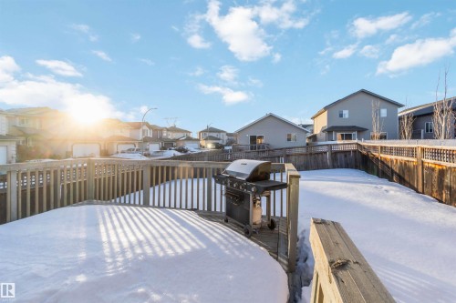 Snow covered deck featuring a residential view, a grill, and a fenced backyard - 4507 164A Avenue, Edmonton, AB - Outdoor