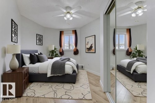 Bedroom with light wood finished floors, a closet, and a ceiling fan - #117 5005 31 Avenue, Edmonton, AB - Indoor Photo Showing Bedroom