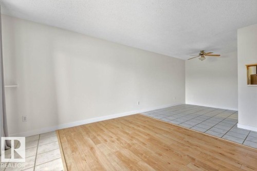 Spare room featuring light tile patterned floors, a textured ceiling, and ceiling fan - #117 5005 31 Avenue, Edmonton, AB - Indoor Photo Showing Other Room