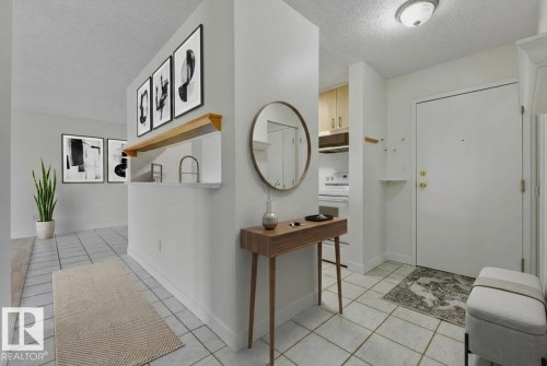 Foyer entrance featuring a textured ceiling and light tile patterned floors - #117 5005 31 Avenue, Edmonton, AB - Indoor