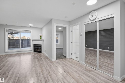 Unfurnished living room with light wood-style flooring and recessed lighting - 115 2098 Blackmud Creek Drive, Edmonton, AB - Indoor