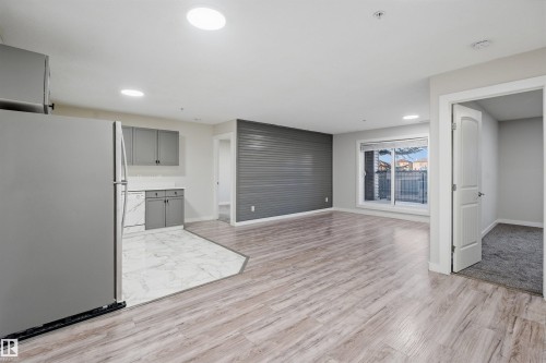 Kitchen with gray cabinetry, stainless steel appliances, light marble finish floors, and recessed lighting - 115 2098 Blackmud Creek Drive, Edmonton, AB - Indoor Photo Showing Kitchen With Stainless Steel Kitchen