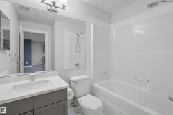 Bathroom with vanity, tub / shower combination, and a textured ceiling - 