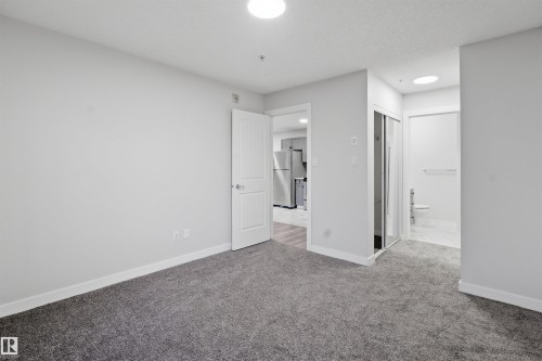 Hallway featuring baseboards and light marble finish flooring - 115 2098 Blackmud Creek Drive, Edmonton, AB - Indoor