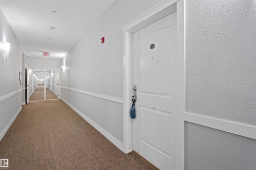 Entryway featuring wood finished floors and baseboards - 115 2098 Blackmud Creek Drive, Edmonton, AB - Indoor Photo Showing Other Room