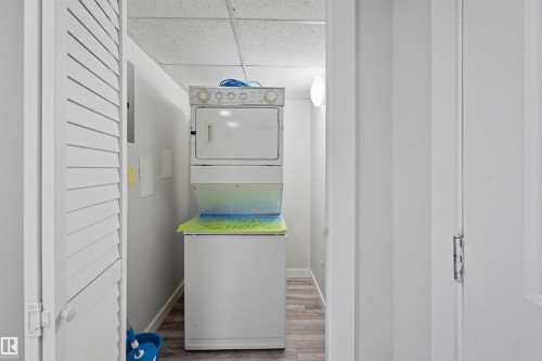 Unfurnished living room with a glass covered fireplace, light wood-style floors, plenty of natural light, and recessed lighting - 115 2098 Blackmud Creek Drive, Edmonton, AB - Indoor With Fireplace