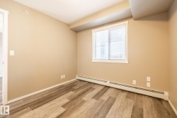 Unfurnished room with a baseboard radiator and light wood-style flooring - 