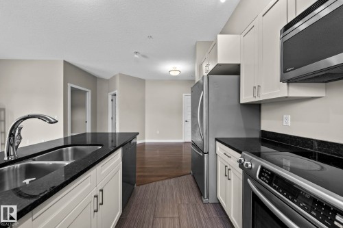 114 1230 Windermere Way Sw, Edmonton, AB - Indoor Photo Showing Kitchen With Stainless Steel Kitchen With Double Sink
