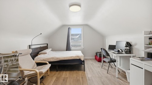 Bedroom featuring light wood-style floors and a desk - 11520 78 Avenue Nw, Edmonton, AB - Indoor