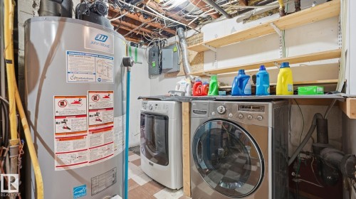 Laundry area with gas water heater, washer and dryer, and tile patterned floors - 11520 78 Avenue Nw, Edmonton, AB - Indoor Photo Showing Laundry Room